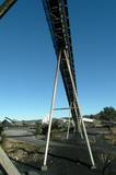 Mining Photo Stock Library - large A frame conveyor with stockpiles of coal in background.  shot from under conveyor.  graduated blue sky behind. ( Weight: 2  New Image: NO)