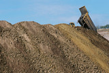 Mining Photo Stock Library - haul truck emptying load of overburden next to many mounds of stockpiles. ( Weight: 1  New Image: NO)