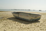 Mining Photo Stock Library - row boat on the sand flats at low tide with boats in the background on the ocean. ( Weight: 3  New Image: NO)