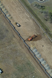 Mining Photo Stock Library - excavator and truck digging trenches to install water pipe for recycled water project. birds eye aerial shot  ( Weight: 5  New Image: NO)