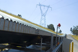 Mining Photo Stock Library - covered overland conveyor with electricity tower nearby. ( Weight: 4  New Image: NO)