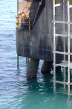 Mining Photo Stock Library - upgrade and maintenance to concrete pylon by worker with jackhammer above ocean.  shipping port. ( Weight: 4  New Image: NO)
