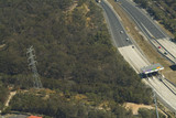 Mining Photo Stock Library - vehicle toll booth and station on a highway with electricity tower and power lines nearby in bush.  ( Weight: 4  New Image: NO)