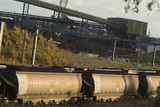 Mining Photo Stock Library - heavy rail coal carriages with conveyors and shiploaders in background. ( Weight: 4  New Image: NO)