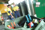 Mining Photo Stock Library - maintenance worker's tool belt with workers out of focus in background. ( Weight: 5  New Image: NO)