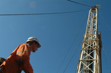 Mining Photo Stock Library - oil rig worker looking to distance with the derrick tower behind. ( Weight: 2  New Image: NO)