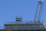 Mining Photo Stock Library - construction workers on pre cast concrete bridge platform organising steel form work with a crane above and behind. vertical shot ( Weight: 4  New Image: NO)