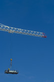 Mining Photo Stock Library - worker in a dog box being lifted by crane high up to a building. very clean shot with lots of sky for text.  vertical shot. ( Weight: 2  New Image: NO)