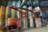 Mining Photo Stock Library - two construction workers on mobile cherry picker in underground tunnel fit form work to concrete posts. ( Weight: 3  New Image: NO)