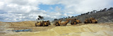 Mining Photo Stock Library - panorama of 3 earth scrapers hauling dirt at a construction site. ( Weight: 3  New Image: NO)