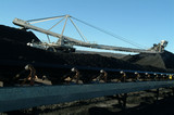 Mining Photo Stock Library - coal reclaimer working at a stockpile with a moving loaded conveyor in the foreground. ( Weight: 4  New Image: NO)