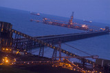 Mining Photo Stock Library - coal terminal with long jetty out to wharf.  shot at sunset with ships in background out at sea. ( Weight: 2  New Image: NO)
