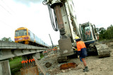 Mining Photo Stock Library - worker drilling pylons  net to QLD light Rail infrastructure track duplication project. train passing by.  great shot. ( Weight: 1  New Image: NO)