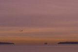 Mining Photo Stock Library - container ship moving through headlands in the distance.  domestic plane flying in low to land at airport.  lots of ocean and great susnet colours.   ( Weight: 2  New Image: NO)