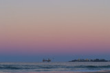 Mining Photo Stock Library - offshore desalination plant drill rig working close to shore with headland and residents cloes by.  beach and waves in foreground. shot at sunset, good colours. ( Weight: 1  New Image: NO)