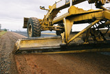 Mining Photo Stock Library - grader working the shoulder of a road.  shot from ground level. ( Weight: 5  New Image: NO)