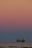 Mining Photo Stock Library - offshore drill rig getting ready to drill. fabulous sky colours with lots of sky in the shot.  desalination plant. vertical image. ( Weight: 1  New Image: NO)