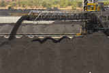 Mining Photo Stock Library - close up of coal falling off a conveyor and being stockpiled.  lots of stockpiles in background.  great generic coal production image. ( Weight: 2  New Image: NO)