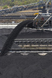 Mining Photo Stock Library - close up of coal falling off a conveyor and being stockpiled.  lots of stockpiles in background.  great generic coal production image. vertical shot. ( Weight: 1  New Image: NO)