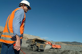 Mining Photo Stock Library - mine site engineer project manager with hand held radio standing near haul truck and digger in open cut coal mine. ( Weight: 2  New Image: NO)