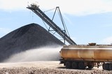 Mining Photo Stock Library - water cart spraying water with coal stockpile in background. ( Weight: 3  New Image: NO)