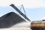Mining Photo Stock Library - water cart spraying water with coal stockpile in background. ( Weight: 1  New Image: NO)