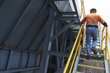 Mining Photo Stock Library - three points of contact on stairs in a mine site.  worker on stairs using yellow guard rails. ( Weight: 1  New Image: NO)