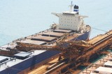 Mining Photo Stock Library - iron ore ship loader working at terminal.  shot shows ship receiving iron ore into hold.  aerial photo. ( Weight: 1  New Image: NO)
