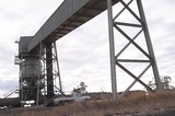 Mining Photo Stock Library - farmer in light vehicle ute passes under overhead coal conveyor loading rail trains in remote, rural area.  car is moving. ( Weight: 1  New Image: NO)