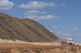 Mining Photo Stock Library - water cart spraying for dust suppression on haul road at open cut coal mine.  overburden stockpiled in background. ( Weight: 1  New Image: NO)
