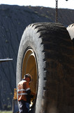 Mining Photo Stock Library - tyre fitter mine worker inspecting haul truck tyre.  great scale.  vertical image. ( Weight: 1  New Image: NO)