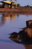 Mining Photo Stock Library - afternoon light reflected on water with haul truck moving in background.  vertical shot. ( Weight: 1  New Image: NO)
