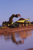 Mining Photo Stock Library - excavator loading overburden into haul truck in late afternoon light.  reflections on water in foreground. ( Weight: 1  New Image: NO)