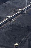 Mining Photo Stock Library - close up aerial photo of tractors stockpiling coal at shipping terminal.  conveyor working above to spread coal. vertical image. ( Weight: 1  New Image: NO)