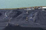 Mining Photo Stock Library - coal dozers with wide blades next to stockpiled coal at shipping terminal.  coal spreader on conveyor nearby. ( Weight: 1  New Image: NO)