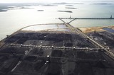 Mining Photo Stock Library - aerial photo of stockpiled coal at shipping terminal with conveyors, loaders and large ship wharf in background. ( Weight: 1  New Image: NO)
