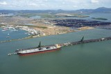 Mining Photo Stock Library - wide aerial shot of a coal ship being loaded at wharf.  stock piled coal in background with reclaimers.  marina close by. ( Weight: 1  New Image: NO)