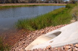 Mining Photo Stock Library - concrete culvert pipe outlet into planted water storage dam on mine site. ( Weight: 1  New Image: NO)