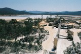 Mining Photo Stock Library - gold mine processing plant with tailings dam in background.  stockpile in foreground.  shot from on top of the stockpile. ( Weight: 1  New Image: NO)