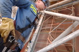Mining Photo Stock Library - dramtaic shot of construction mine worker in full PPE and wearinf confined space harness.  scaffolding around worksite in background. ( Weight: 1  New Image: NO)