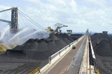 Mining Photo Stock Library - great aerial wide shot of a coal terminal.  water sprayers for dust suppression, workers completing maintenance, reclaimers working in the background and stockpiles of coal. ( Weight: 1  New Image: NO)