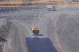 Mining Photo Stock Library - water cart spraying water on road in haul truck dump turnaround area.  dust suppression. ( Weight: 1  New Image: NO)