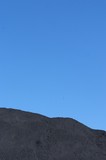 Mining Photo Stock Library - generic close up shot of a coal stock pile.  blue sky in the background. ( Weight: 1  New Image: NO)
