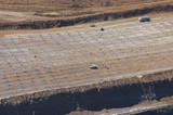 Mining Photo Stock Library - aerial photo of blast worker loading shot holes at open cut mine site.  hundreds of blast hole patterns all around. ( Weight: 1  New Image: NO)