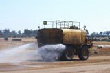 Mining Photo Stock Library - water cart spraying water on haul road in a mine. ( Weight: 1  New Image: NO)