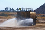 Mining Photo Stock Library - water cart spraying water on haul road in a mine. ( Weight: 1  New Image: NO)