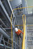 Mining Photo Stock Library - mine worker in full PPE walking down steps of a mining plant safely using three 3 points of contact. ( Weight: 1  New Image: NO)