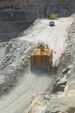 Mining Photo Stock Library - vertical shot of water cart spraying access road on bench in a quarry.  drilling rig in background and worker in full PPE with light vehicle. ( Weight: 1  New Image: NO)