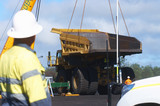 Mining Photo Stock Library - haul truck tray bering lifted by a crane off the back of a haul truck at a mine site workshop.  worker in full PPE observing. ( Weight: 1  New Image: NO)