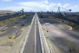 Mining Photo Stock Library - wide aerial shot of a coal terminal.  Reclaimers working coal stockpiles.  light vehicles on access road give scale. ( Weight: 1  New Image: NO)